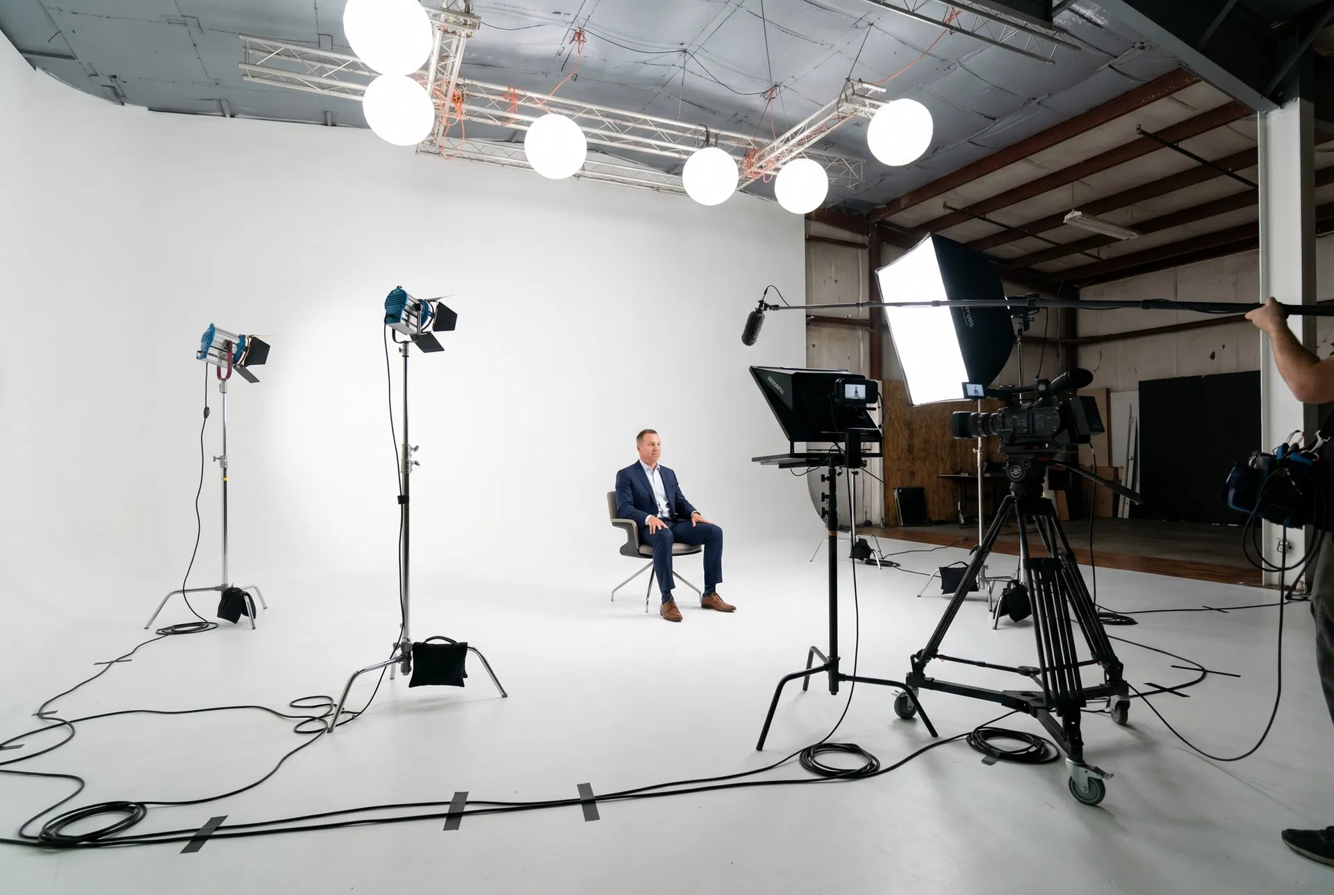 Executive interview on white cyc with teleprompter and softbox