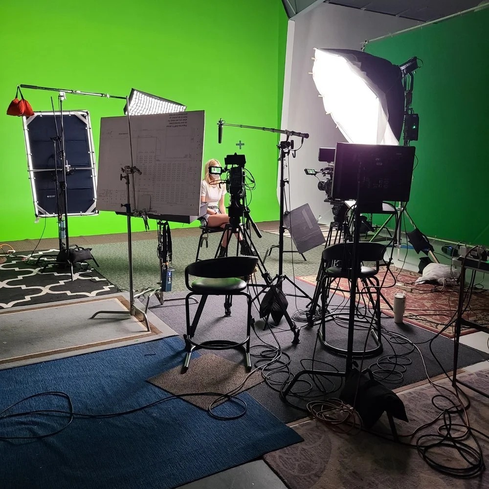 Green screen interview setup with softbox and monitors