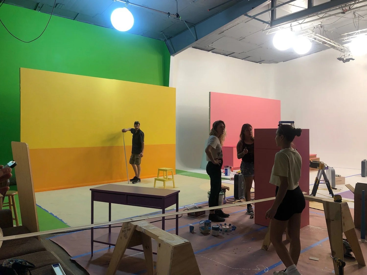 Production design team building color blocks on set
