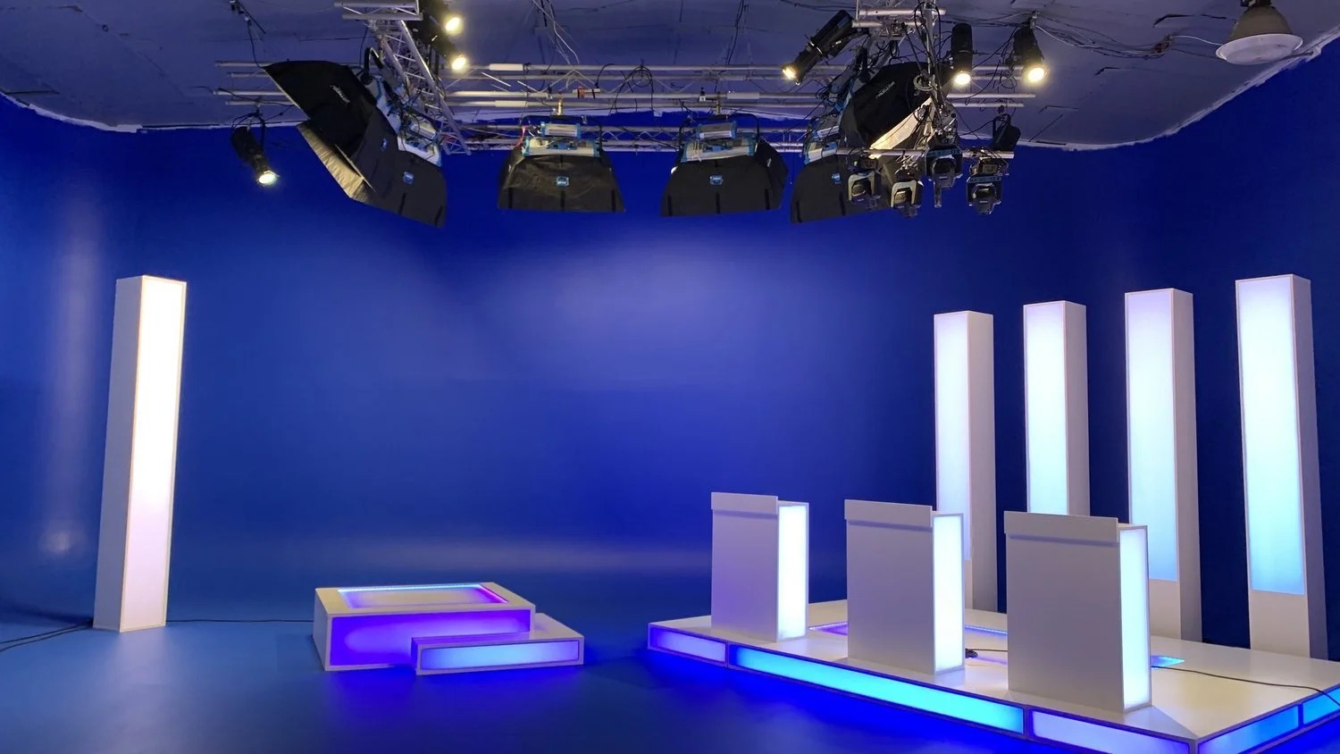 Blue lit stage with illuminated columns for a music video