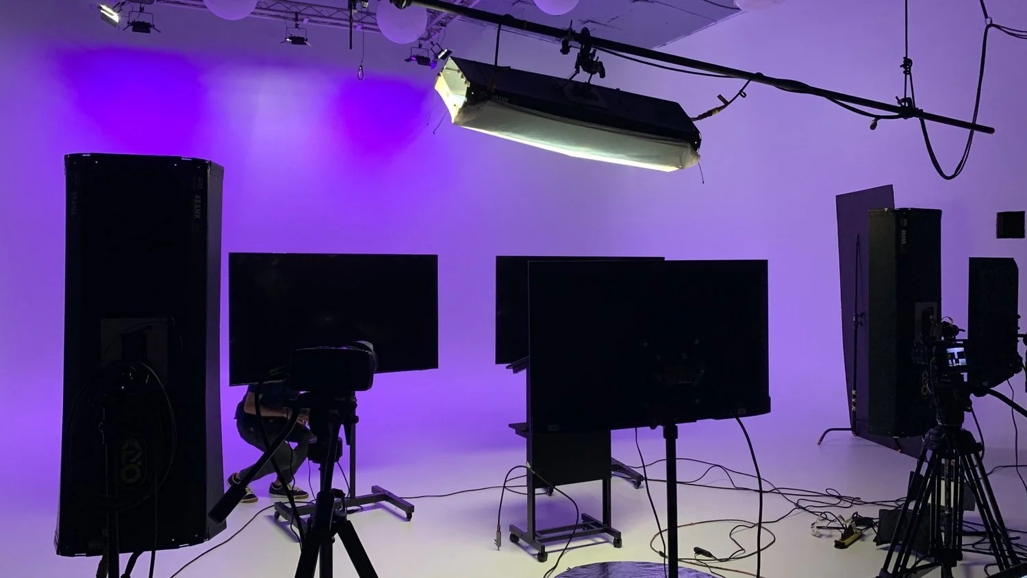 Multi-camera shoot with monitors and purple wash
